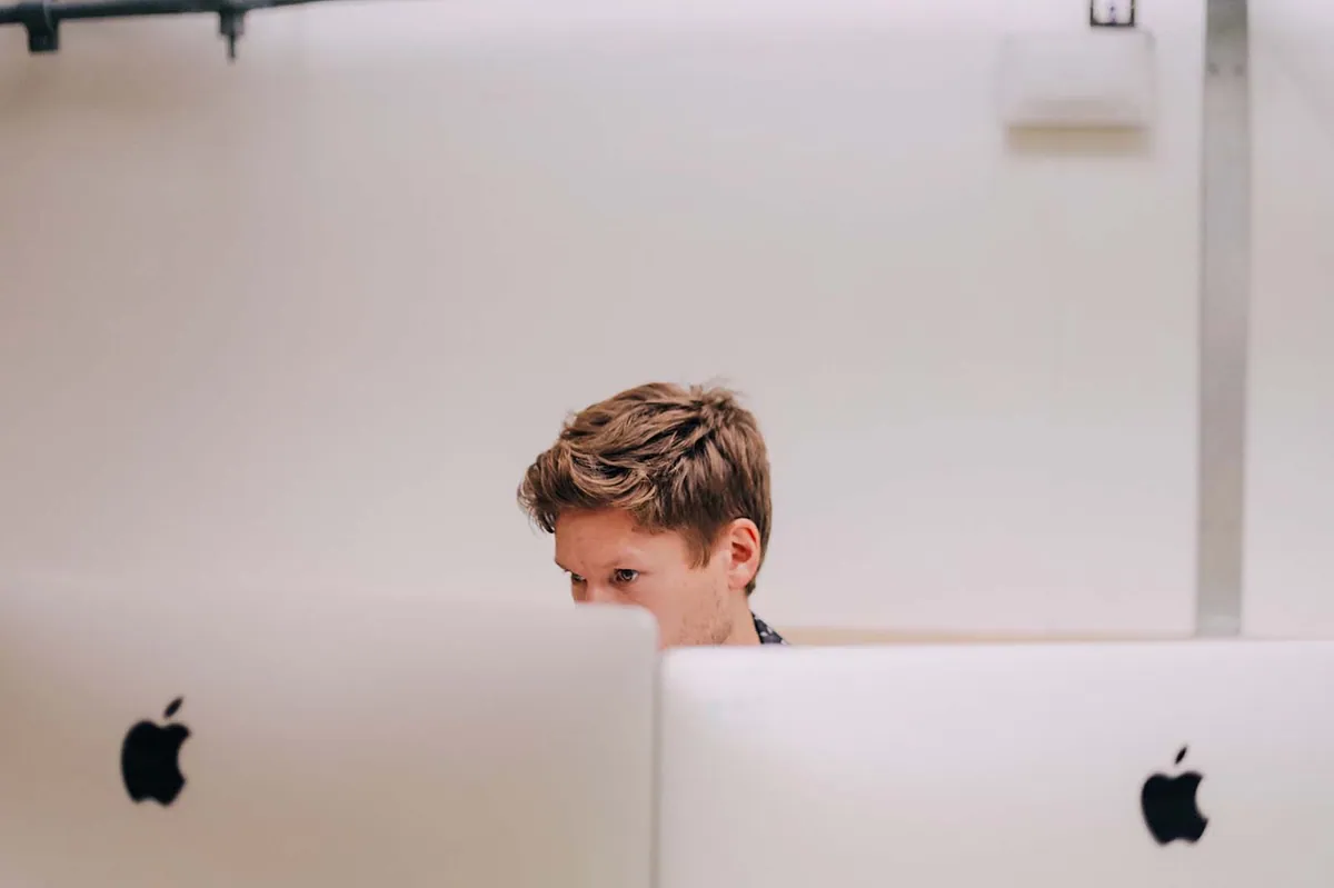 Photo of Matt Rogers behind a computer