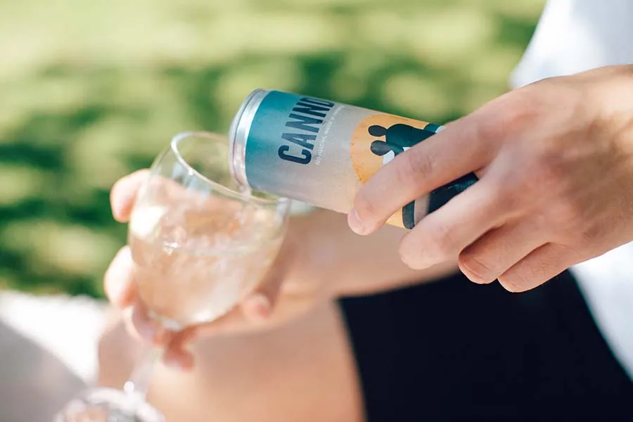 Cannd lifestyle image showing a person opening a can